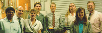 Photo of a typical project team, showing eight people standing
